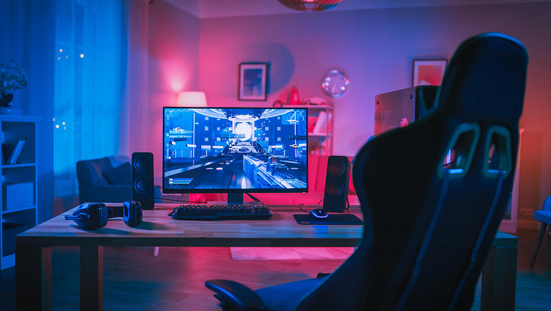 a desk with a computer and a chair